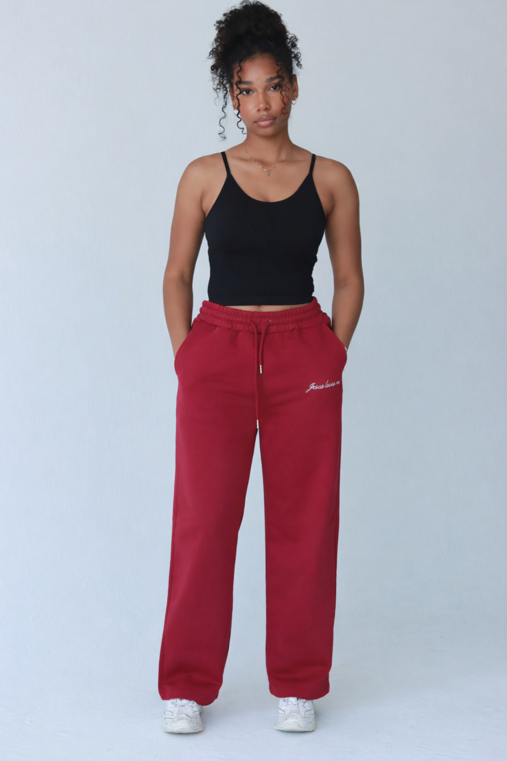 Person wearing a red tracksuit with text on a white background