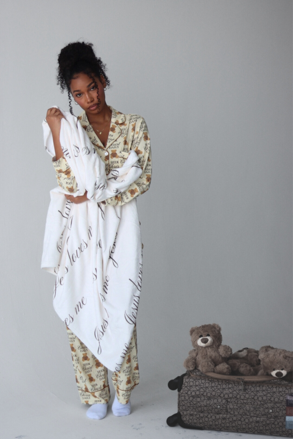 Blanket with 'Jesus loves me' text on a plain background