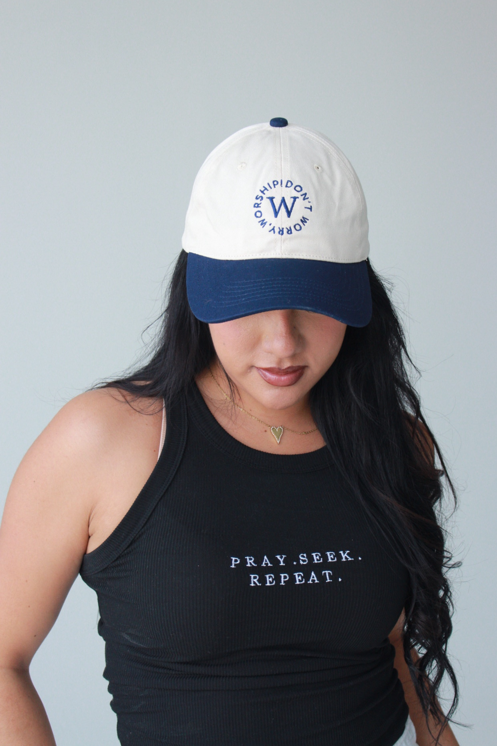 White and navy cap with text on a light gray background